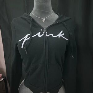 black hoodie with white cursive “pink” logo